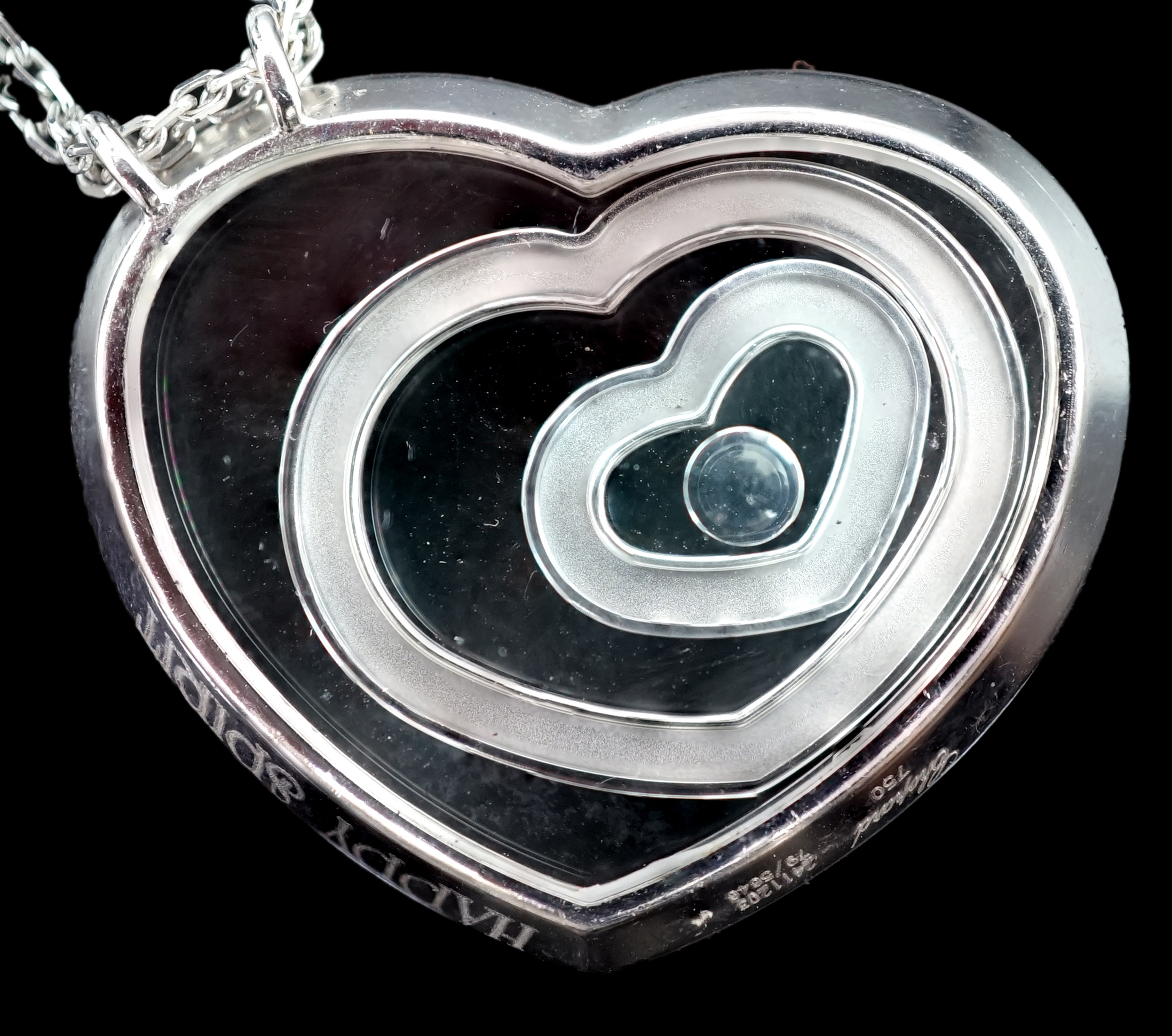 A modern Chopard 18ct white gold and diamond set 'Happy Spirit' heart shape pendant, on a Chopard 18ct white gold double strand fine link chain